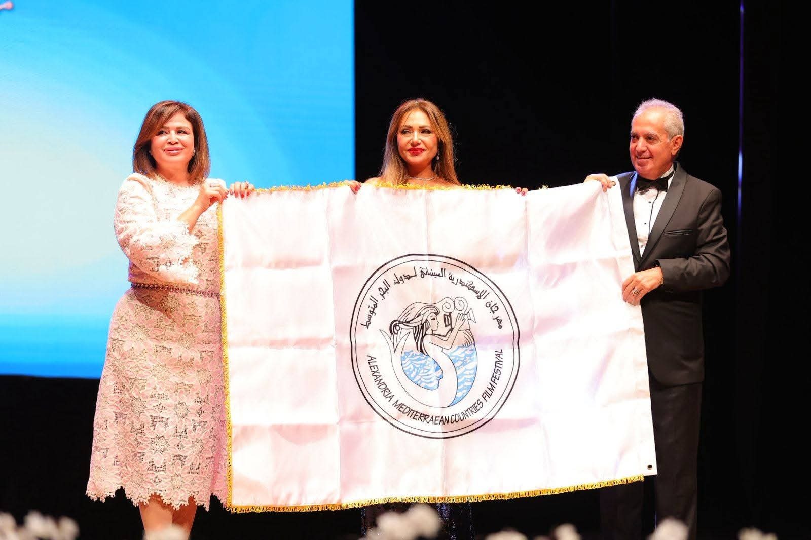 الممثلة المصرية ليلى علوي تتسلم علم الدورة الـ 41 لمهرجان الإسكندرية السينمائي لدول البحر المتوسط والتي تحمل اسمها، من سابقتها الممثلة إلهام شاهين، الإسكندرية، مصر. 2 أكتوبر 2025